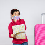 front view female tourist holding map mask white wall